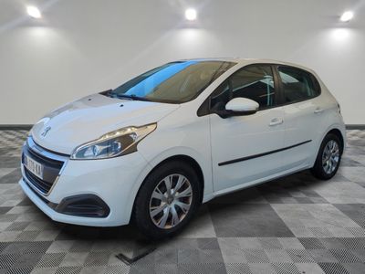 the small white car is parked in the garage on a checkered floor