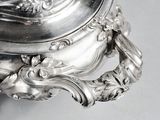 a silver plate with a lid on a table