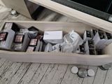a wooden box filled with makeup items on a wooden floor