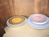 three plates sitting on a chair in front of a wooden wall