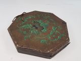 a small wooden box with a green design on it