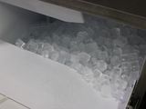 a freezer with ice inside of it on a counter