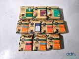 several packages of coffee sit on a table next to each other