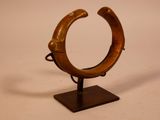 a wooden ring with a handle on a stand