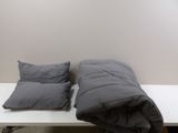 two pillows sitting on a white table next to each other
