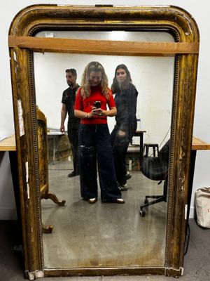 a woman taking a picture of herself in a mirror