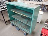 a green cabinet with a shelf on top of it