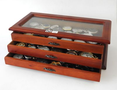 a wooden box with a glass top that has a watch inside of it