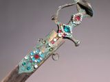 a very old looking knife with a very pretty design on it