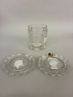 two clear glass dishes and a glass cup on a white surface