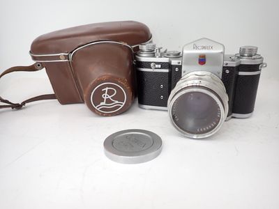a camera and a coin sitting on a table