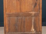 an old wooden dresser sitting on top of a cement floor