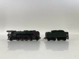 two toy trains sitting side by side on a white surface