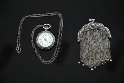 a silver pocket watch and a chain with a chain around it