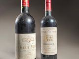 two bottles of wine sitting next to each other on a table