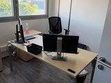 a desk with two monitors and a laptop on it