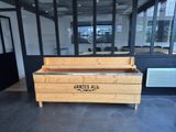 a wooden bench in the middle of a large room