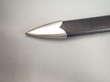 a black pen with a silver tip sitting on a table