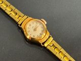 an image of a close up of a wrist watch on a table