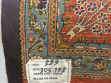 an old rug with a tag on it sitting on a table