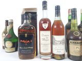 bottles of different types of alcohol lined up on a white surface