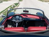 a red and black convertible car parked on the side of the road