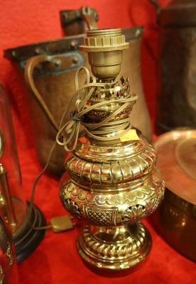 a gold lamp that is sitting on a red table