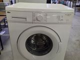 a washing machine that is sitting in the middle of a room