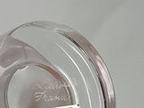 a glass vase with a label on it sitting on a table