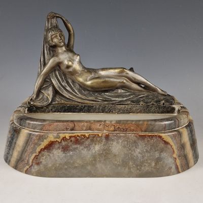 sculpture of a woman reclining on a marble base