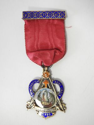 an image of a medal with a star and a cross on it