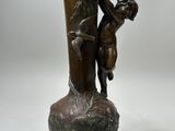 a bronze vase with a boy and a girl on it