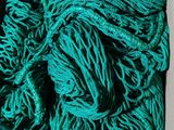 a pile of green yarn sitting on top of a table