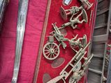 a lot of silver figurines on display in a case