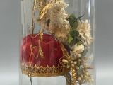 a glass dome with a teddy bear inside of it