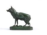 une statue en bronze représentant un loup, posée sur un socle vert