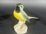 a figurine of a bird sitting on top of a table