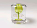 a glass with a yellow liquid inside of it