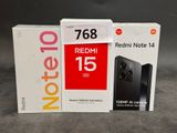 deux boîtes contenant un Redmi Note 14 et un Redmi Note 14 posées sur une table