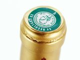 a close up of a bottle of wine on a white surface
