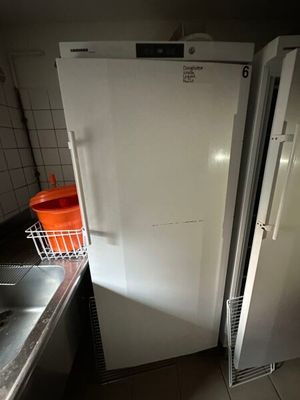 a refrigerator and a sink in a small kitchen