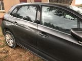 a black car parked in front of a house