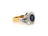 a close up of a blue sapphire and diamond ring on a white background