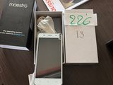 a white cell phone sitting in a box on a table