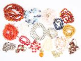 a lot of beads and bracelets on a white surface