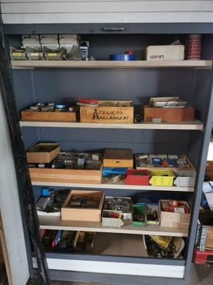 a shelf full of assorted items in a garage
