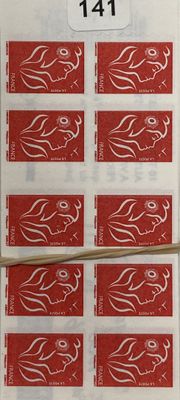 un gros plan sur une feuille de timbres rouges posée sur une table