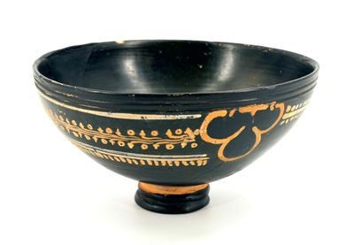 a black and gold bowl on a white background