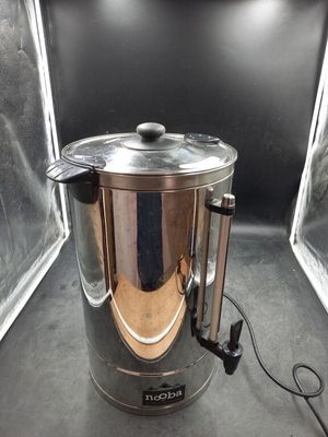 a silver kettle sitting inside of a glass case