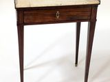 a small wooden table with a marble top on it